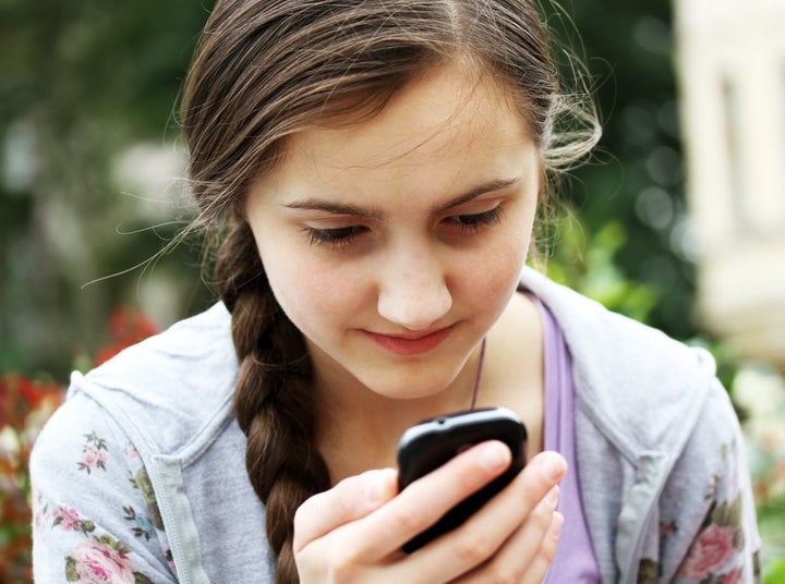 girl playing on mobile phone