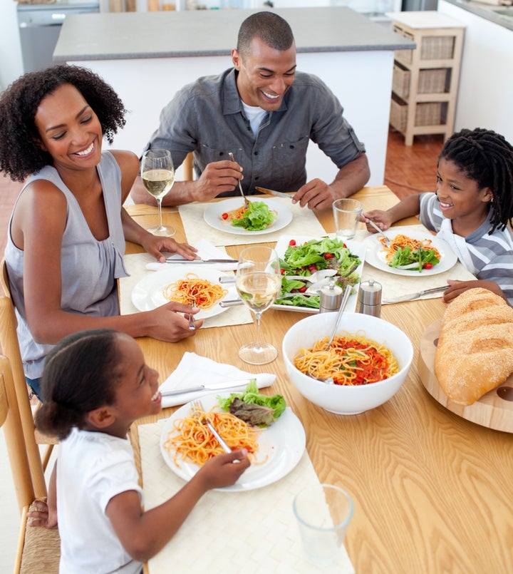 Smiling family dining together in the kitchen