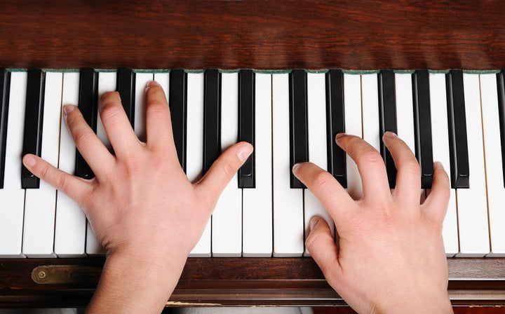 the hands of a pianist in...