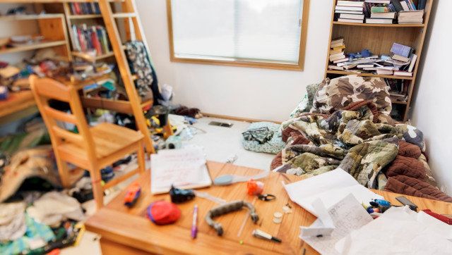 Teenage boy's messy room. Tilt shift lens, with focus on pillow & comforter