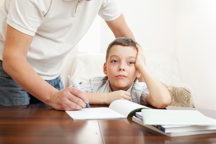 Father helping son do homework. Problems with homework