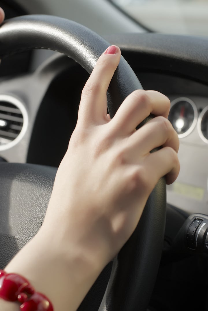 girl hand on wheel steering on...