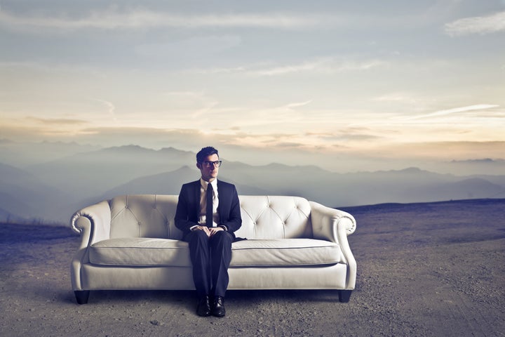 businessman sitting on a white...