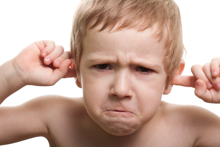 Worried human child boy face hand finger close ear