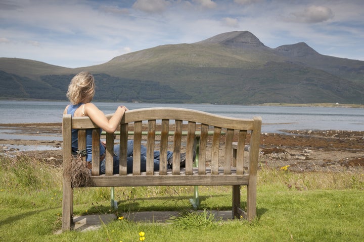 young woman sitting on bench on ...