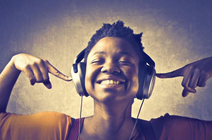Smiling african woman listening to music