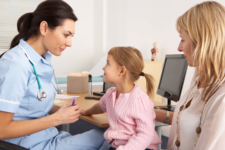 British nurse about to inject young child