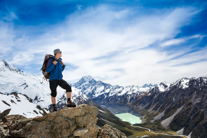 hiker at the top of a rock with ...