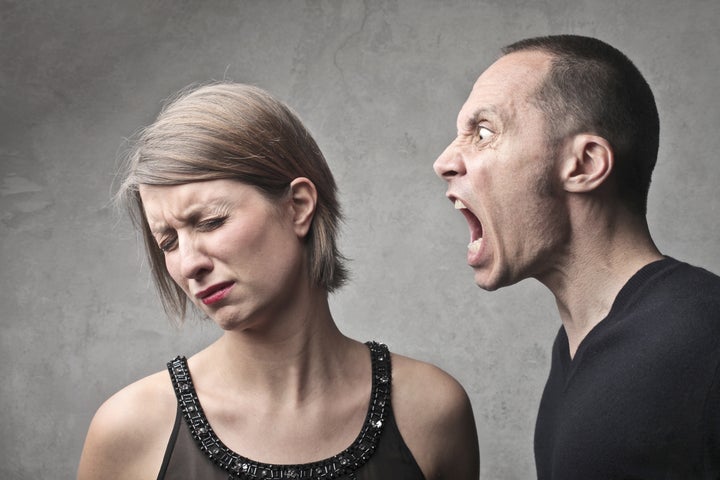 Young man screaming against a sad young woman