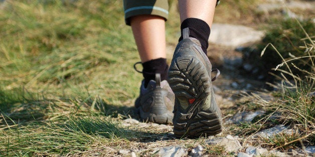 Hiking Boots/Hiking Boots and Legs of a Woman on the Mountain Path