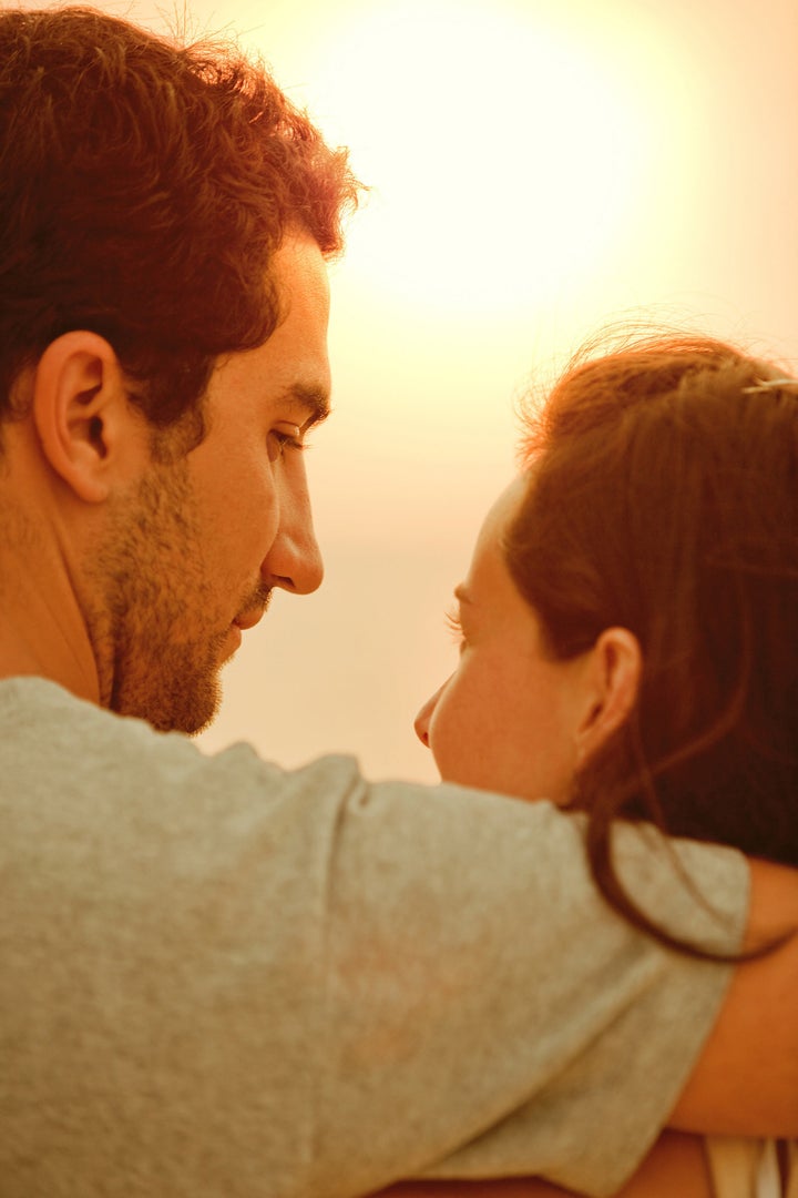 Portrait of a loving couple watching the sunset