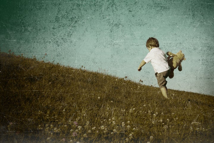 young boy climbing hill