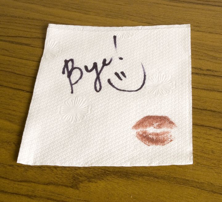 Word Bye, lipstick and a smiley face on the napkin