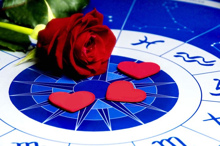 red rose and heart shapes on an astrological plan