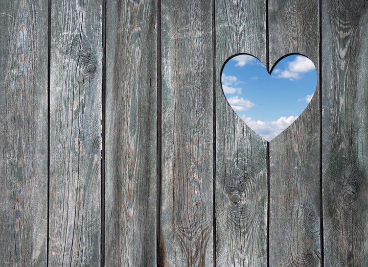 blue sky hole in a wooden wall background