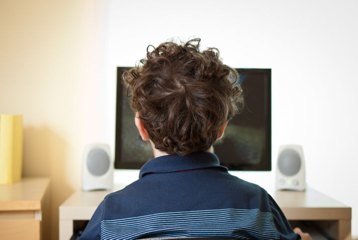 Boy using computer at home