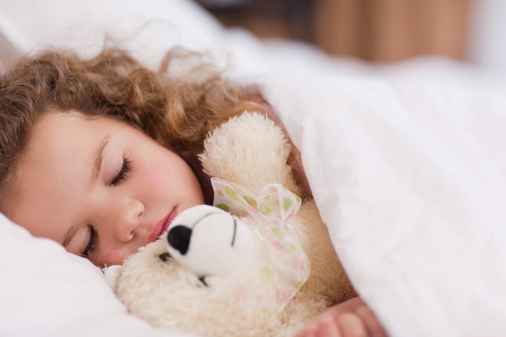 Little girl sleeping with her daddy