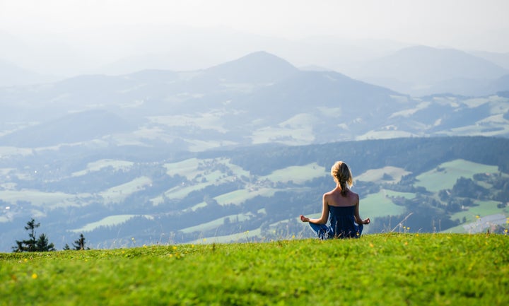 Young woman meditating outdoors