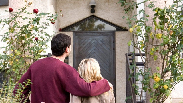 couple in front of the house