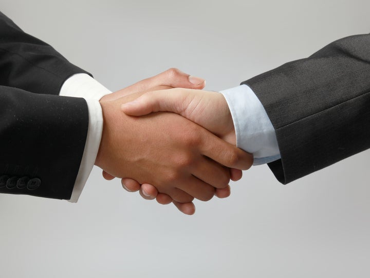 Closeup of a business handshake on white background