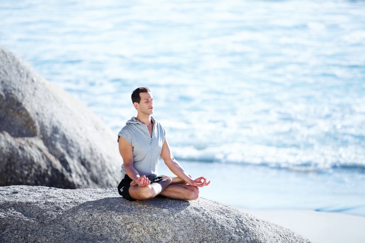 handsome young man meditating...