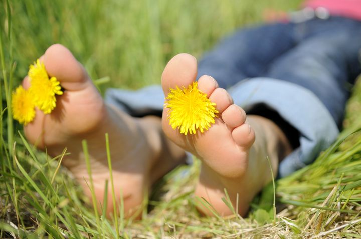 young woman is barefoot in a meadow