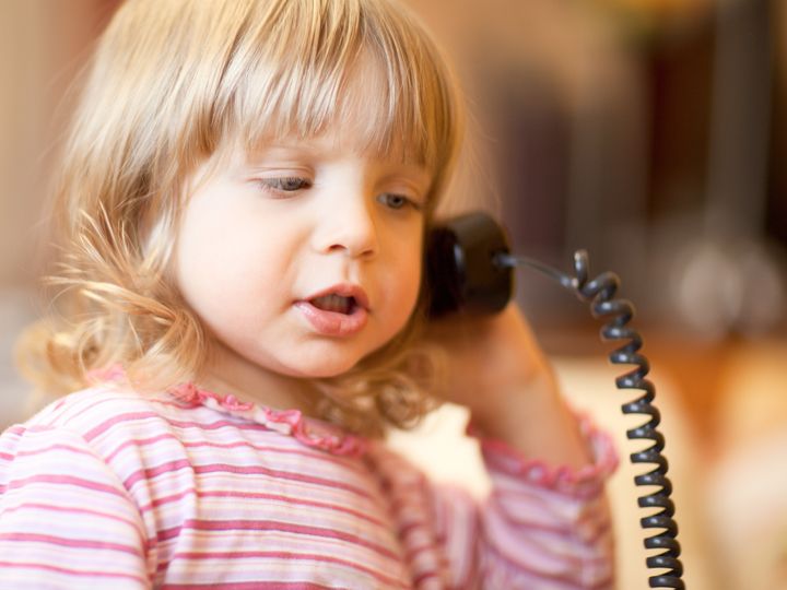 Little girl calling phone - shallow DOF, focus on front eye