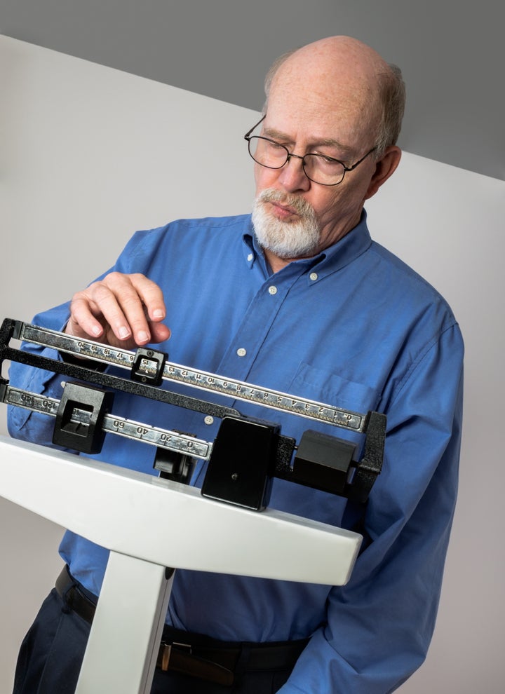 senior caucasian man weighing...