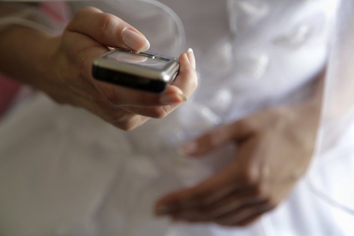 Fiancee with mobile telephone in hands