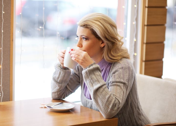 Portrait of young pretty woman drinking coffee in restaurant