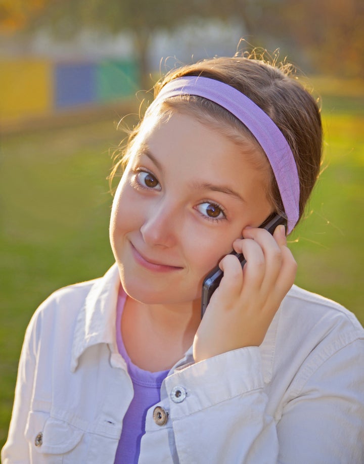 girl speaking on cell phone at...