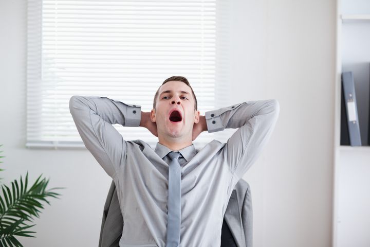 Tired businessman yawning