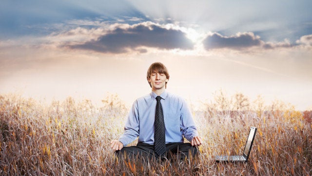 Businessman meditating in lotus pose. Business yoga