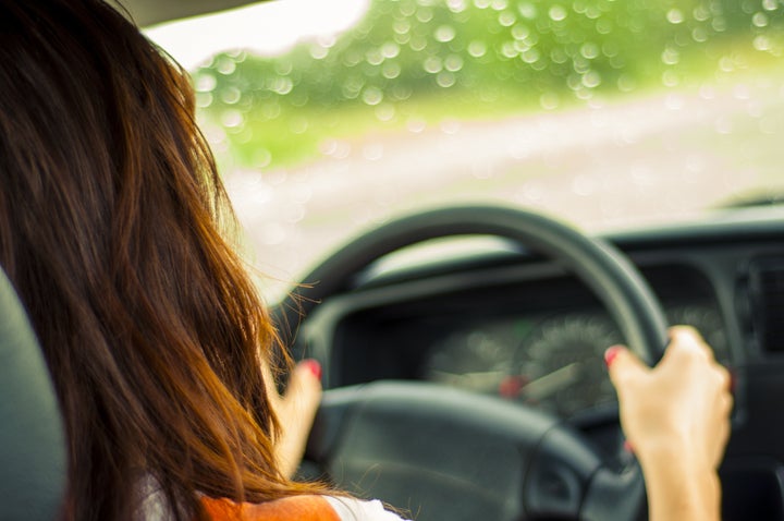 Hands of a female driver on steering wheel