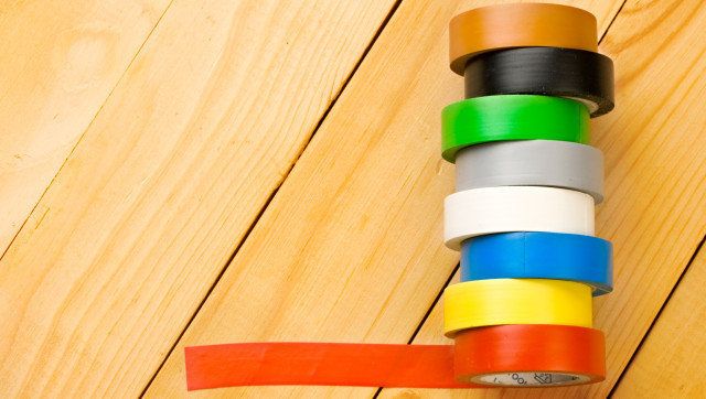 Insulation tape isolated on wooden background
