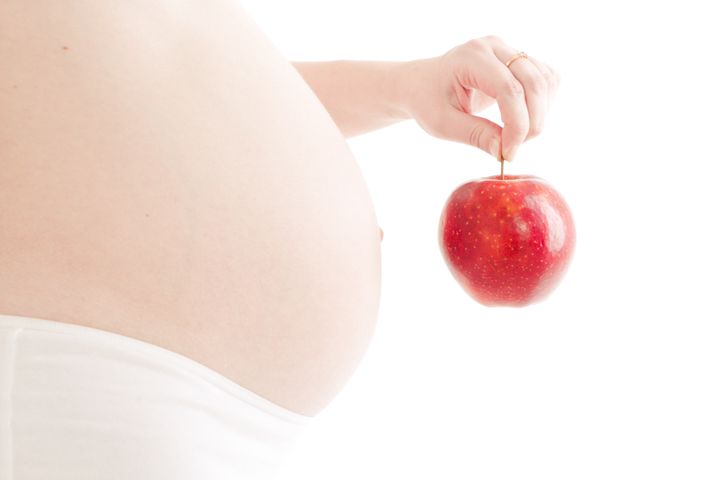 pregnant woman with red apple