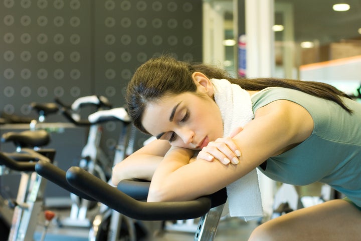 Woman resting on exercise bike