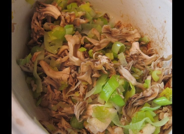 Leeks and hen-of-the-woods mushrooms cooking with butter