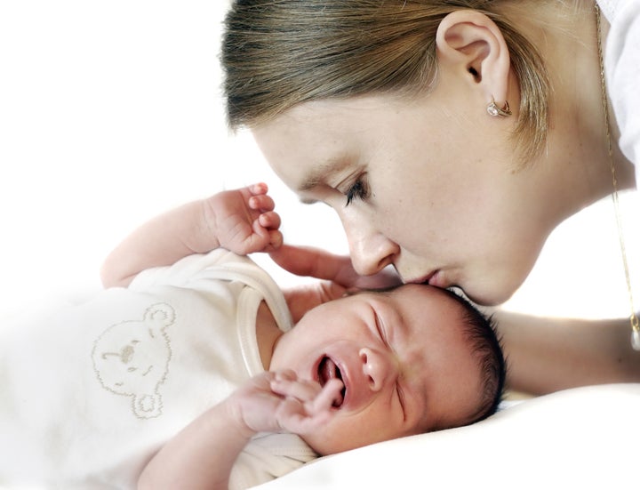 Mum kissing crying baby