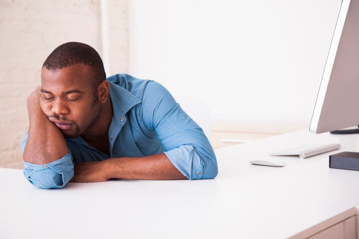 Black businessman sleeping at desk