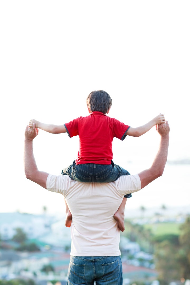 Father giving son piggyback ride outdoors