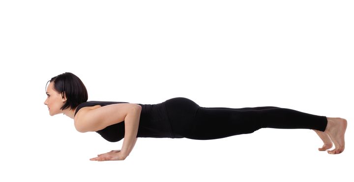 woman lay in yoga arm balance...
