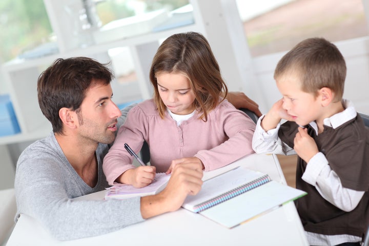Man helping kids with homework