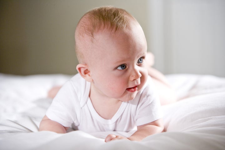 Six month old baby with staring with blue eyes