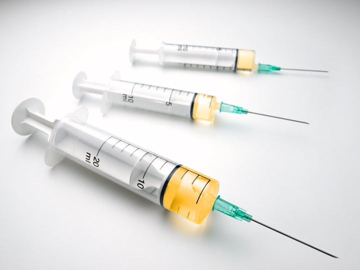 syringes over white surface, for medical,healthcare or pharmacy themes