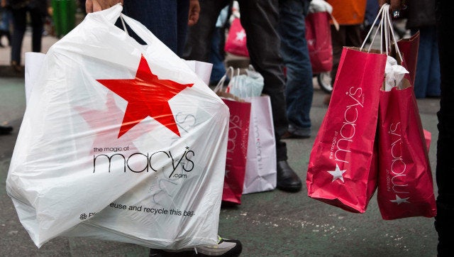 NEW YORK, NY - DECEMBER 26: People wait to cross the street after shopping at Macy's department store on December 26, 2012 in New York City. Shoppers flooded Manhattan stores for post-Christmas deals throughout the day. (Photo by Andrew Burton/Getty Images)