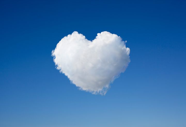Cloud against blue sky in the shape of heart.