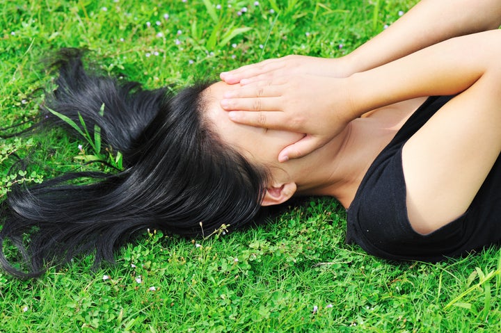 depress woman on green grass