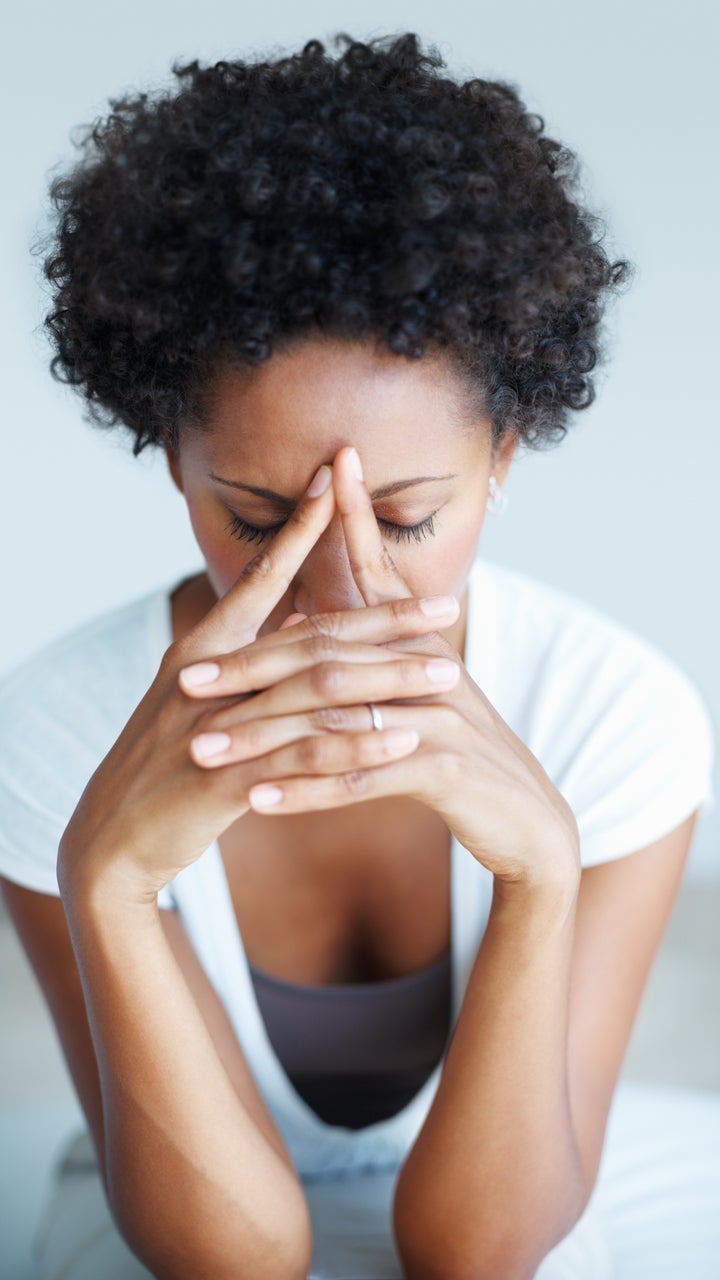 Portrait of African American woman suffering from illness or headache