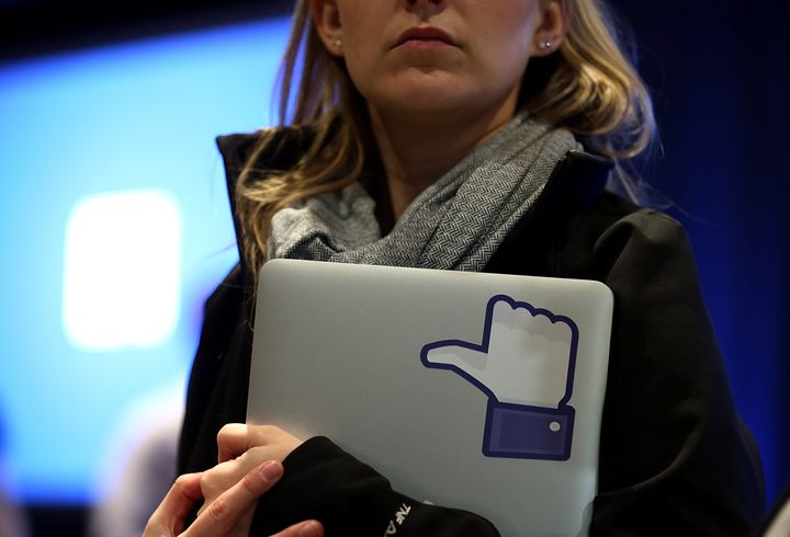 MENLO PARK, CA - APRIL 04: A Facebook employee holds a laptop with a 'like' sticker on it during an event at Facebook headquarters during an event at Facebook headquarters on April 4, 2013 in Menlo Park, California. Facebook CEO Mark Zuckerberg announced a new product for Android called Facebook Home as well as the new HTC First phone that will feature the new software. (Photo by Justin Sullivan/Getty Images)